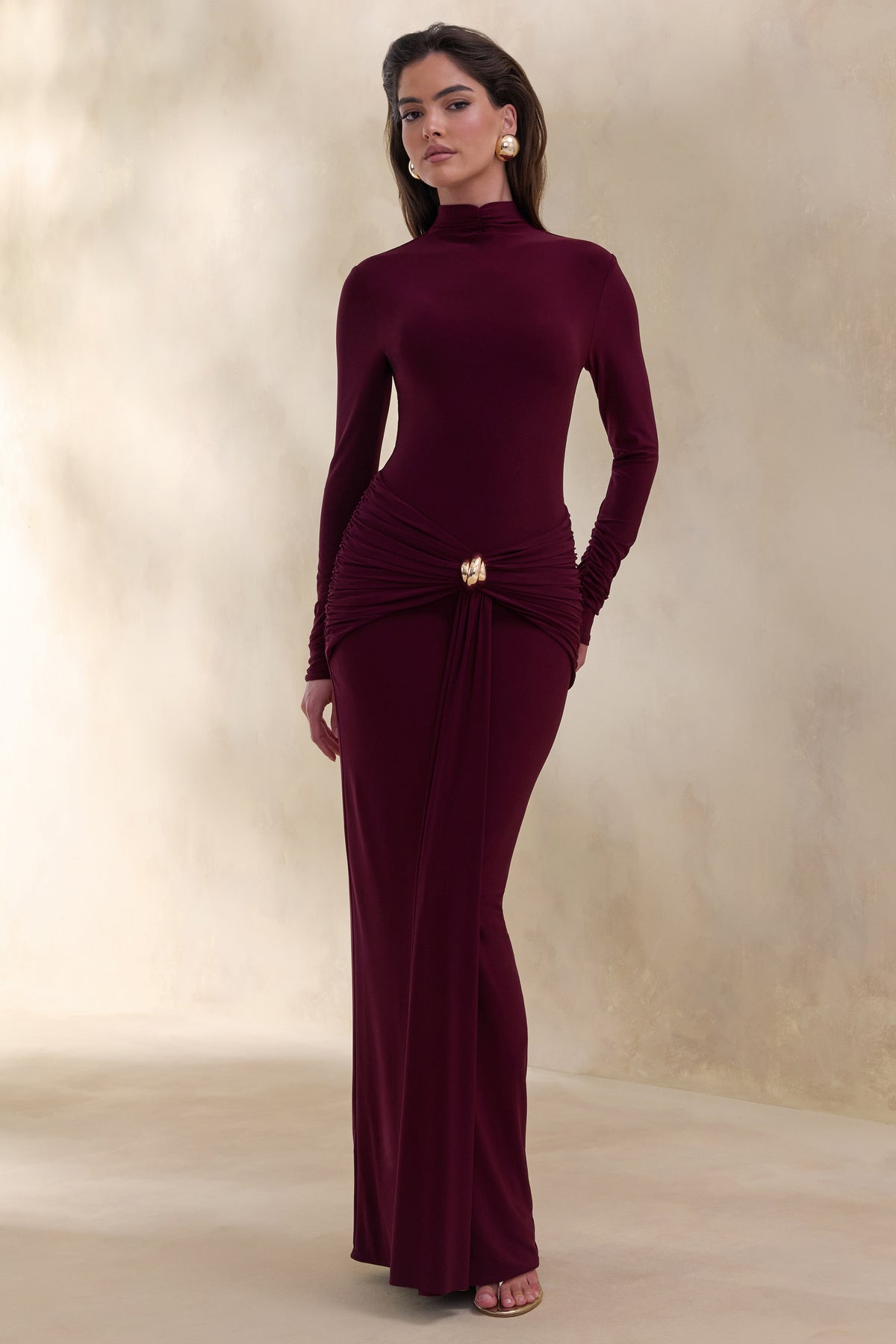 Woman wearing a deep plum maxi dress as a wedding guest