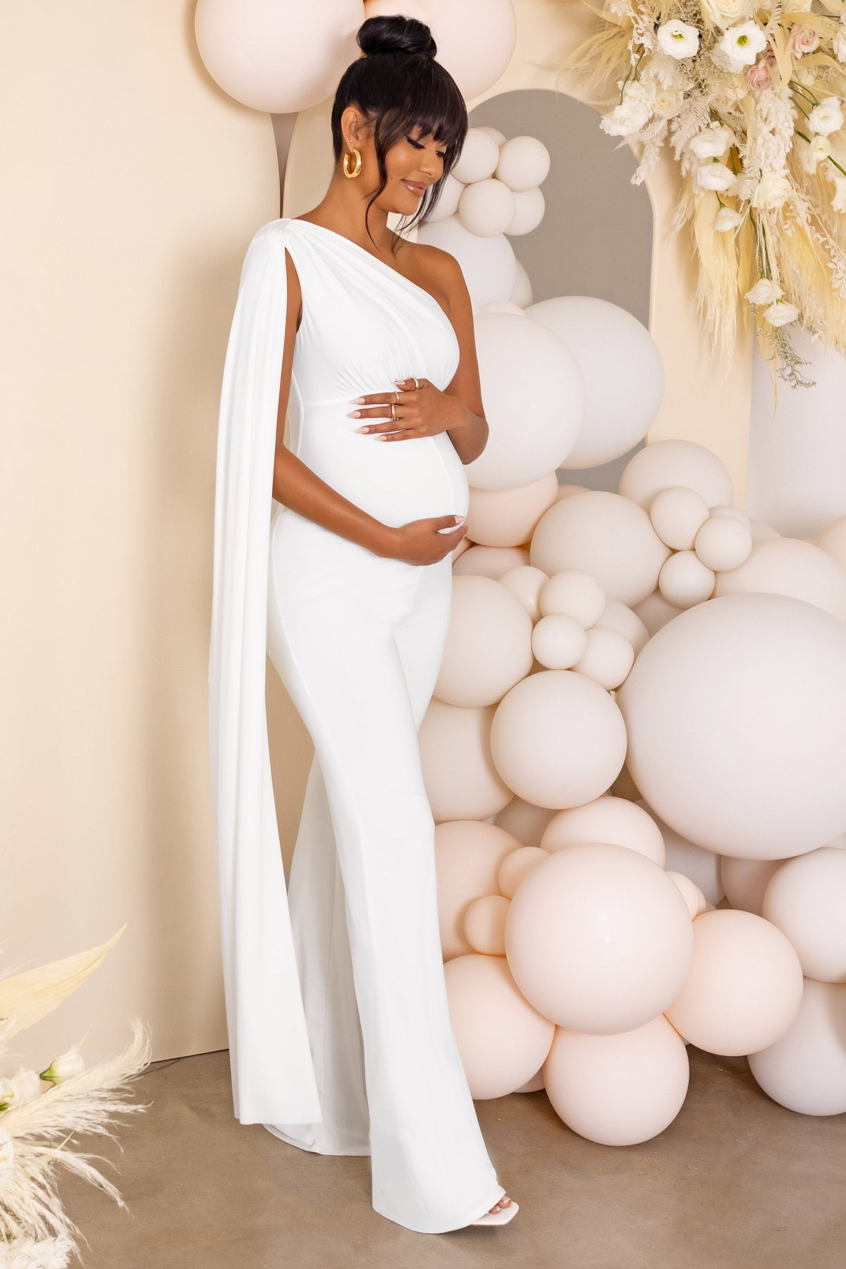 https://clubllondon.us/cdn/shop/products/CL126472-white11-maternity-one-shoulder-cape-jumpsuit-6_ca4fcf59-04a1-40cf-bf1d-26b969eecdfc_1200x.jpg?v=1692136642