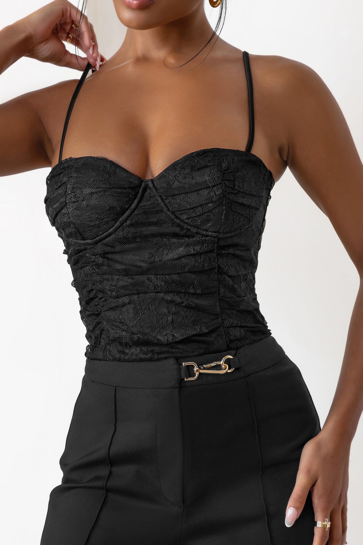 Close-up shot of a black openwork bustier top with structured cups